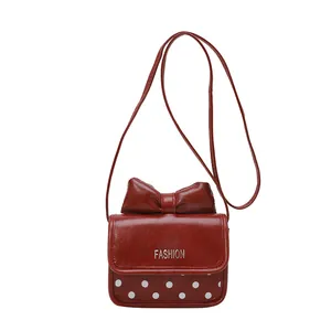 Cute kids red crossbody bag with bow decoration and white polka dots pattern