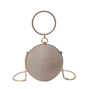 Sac de soirée sphérique doré avec poignée anneau en strass et bandoulière amovible