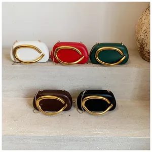 Classic round box clutch bags in various colors with gold metal handles and chain straps