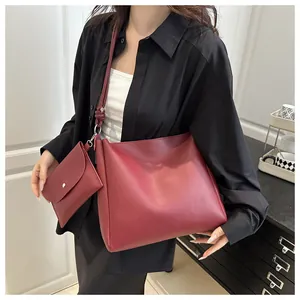 Detailed view of burgundy PU leather tote bag with knotted strap and small pouch