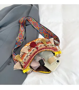 Detail of bohemian tassel bag with woven strap showing phone and makeup storage space