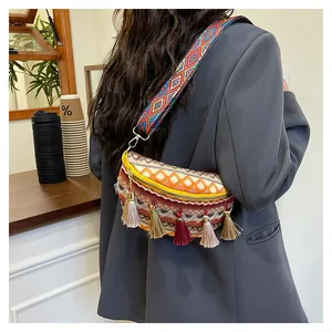 Close-up of bohemian crossbody bag featuring colorful geometric weave and tassel details