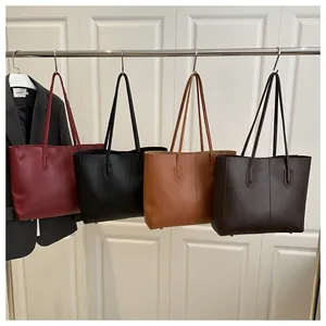Detail view of four minimalist tote bags in burgundy, black, brown and dark coffee colors