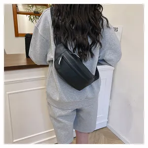 Rear view of model wearing a black minimalist waterproof waist bag with adjustable strap