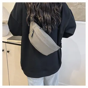 Detailed back view of a khaki fanny pack worn crossbody with adjustable black nylon strap