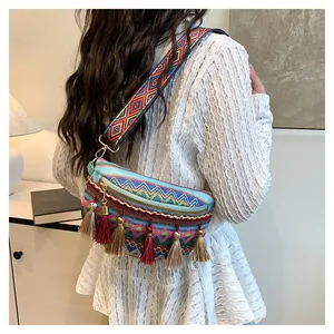 Detail of colorful woven bohemian crossbody bag with long tassels and embroidered strap
