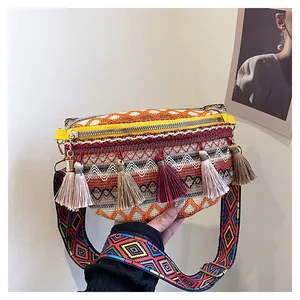 Detailed embroidery and silk tassels on bohemian woven crossbody bag with ethnic strap
