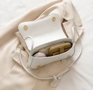 Interior view showing capacity for smartphone and wallet in white textured leather bag