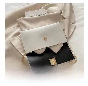 Detail view of contrast chain bag showing interior capacity for makeup and accessories