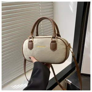 Close-up of canvas Boston bag with leather handles and Fashion & Bags text on white background