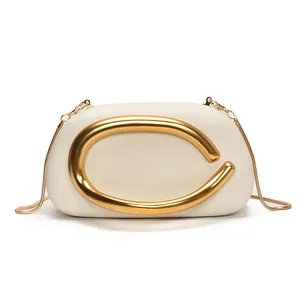Minimalist beige leather evening clutch with gold C-shaped buckle and fine snake chain