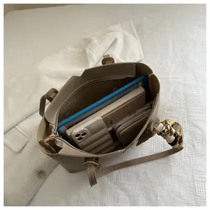 Spacious khaki tote bag interior showing capacity for tablets and books with silk scarf detail