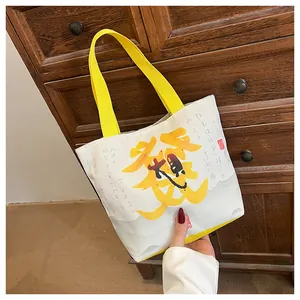 Detail of canvas bucket bag with yellow handle and Chinese calligraphy on retro background