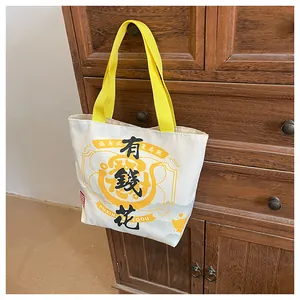 Detail of canvas bucket bag hanging on a vintage wooden cabinet with yellow straps