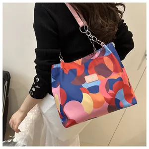 Detailed view of women's tote bag featuring vibrant geometric rings and chain strap