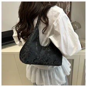 Detail of black snake pattern texture on the hobo shoulder bag with bottom rivets