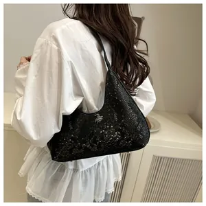 Detail showing high-end black snake pattern embossed texture on minimalist hobo bag