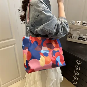Women's colorful geometric tote bag with nylon finish and chain strap details