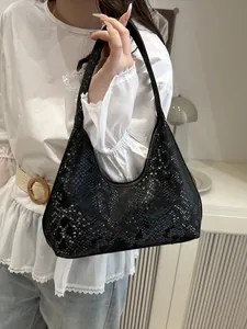 Minimalist black faux snake skin underarm bag with embossed fashion text detail