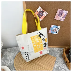 Detail of canvas bucket bag with Chinese Money Bag print and yellow handles