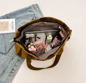 Top view of striped canvas tote bag showing spacious interior with zipper closure and items