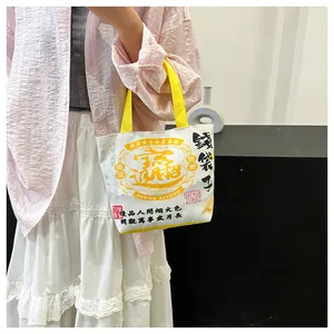 Close-up of canvas bucket bag with traditional Chinese calligraphy and yellow handles