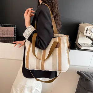 Close-up of striped canvas tote bag showing heavy texture and dual carrying handles