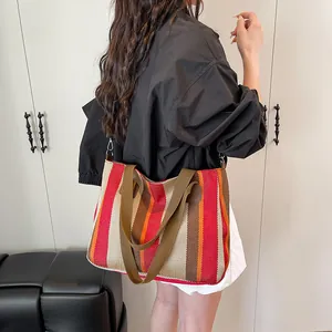 Large striped canvas tote bag with brown handles and detachable shoulder strap for women