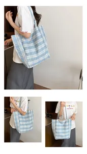 Detail of blue and white checkered canvas tote bag showing fabric texture and shoulder straps