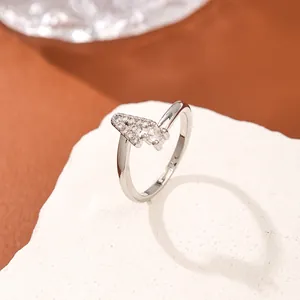Polished silver letter A ring with micro-p鑲ed zircon stones on a white stone background