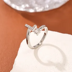 Silver open ring with micro-pave letter L and round zircon on a textured stone base