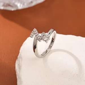 Detail view of silver S925 ring with Z-shape geometric design and micro-pave zircons