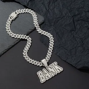 Macro shot of silver hip-hop chain with BANK letter pendant featuring iced out rhinestones