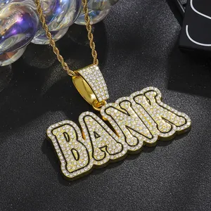 Detail shot of iced out BANK pendant necklace with gold rope chain for hip hop style
