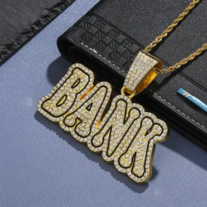 Macro detail of iced-out gold BANK pendant necklace with white rhinestones on twist chain