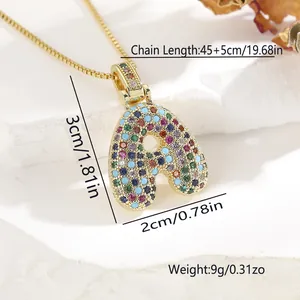 Macro view of golden letter A pendant necklace with colorful cubic zirconia inlay