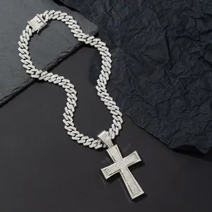 Macro shot of silver hip hop Cuban link chain and oversized iced-out cross pendant