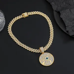 Macro shot of hip hop Eye of Horus pendant with blue stone and Cuban chain crystals