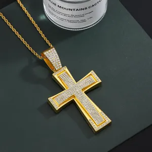 Close-up of gold iced out cross pendant with cubic zirconia on a rope chain necklace
