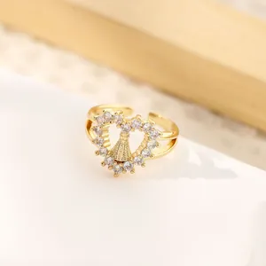 Detailed macro shot of an 18K gold-plated heart ring featuring a religious Virgin Mary icon