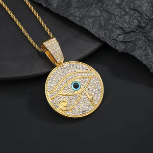 Detailed macro view of gold plated Eye of Horus medallion necklace with white crystals