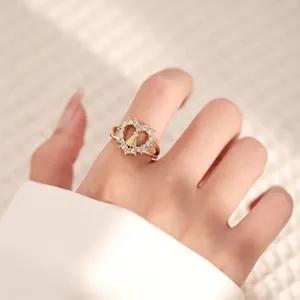 Macro detail of 18K gold-plated ring with Virgin Mary icon and sparkling zircon halo