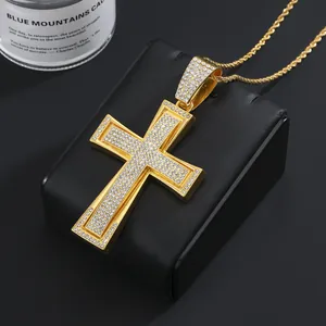 Detailed view of hip hop gold cross pendant with iced out rhinestones and rope chain