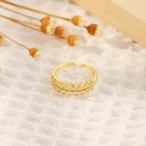 Detail of 18K gold plated ring with double-row zircon stones in a crown design