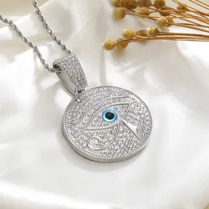 Macro detail of silver iced out evil eye pendant with blue iris on twisted rope chain