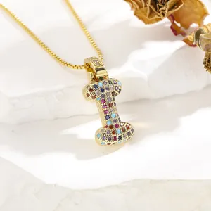 Detailed close-up of golden letter I pendant with vibrant multi-color zircon micro-inlay
