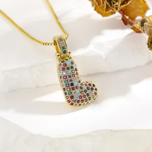 Close-up of heart pendant necklace with multi-colored pavé-set zircons on gold box chain