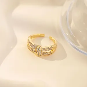 Detailed view of an 18K gold plated adjustable ring with pavé-set shimmering zircon stones