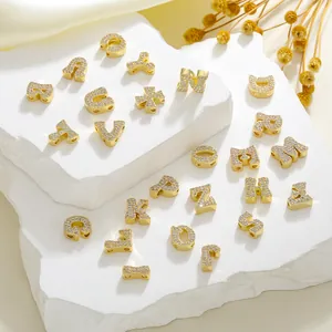 Macro shot of gold-plated copper A-Z letter charms with micro-pave white zircon stones