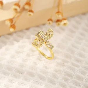 Detail of 18K gold-plated geometric ring with sparkling zircons on soft knit fabric